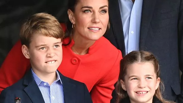 Kate Middleton bending down to talk to Prince George and Princess Charlotte