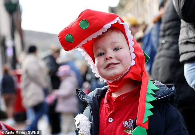 Pictured, a delighted royal wellwisher awaits for the Prince and Princess of Wales' arrival this morning