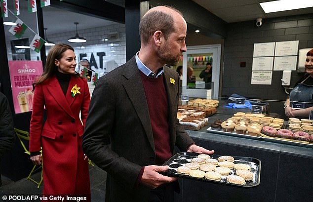 The royal couple walked outside with baked goods, as they met with wellwishers in Wales this afternoon