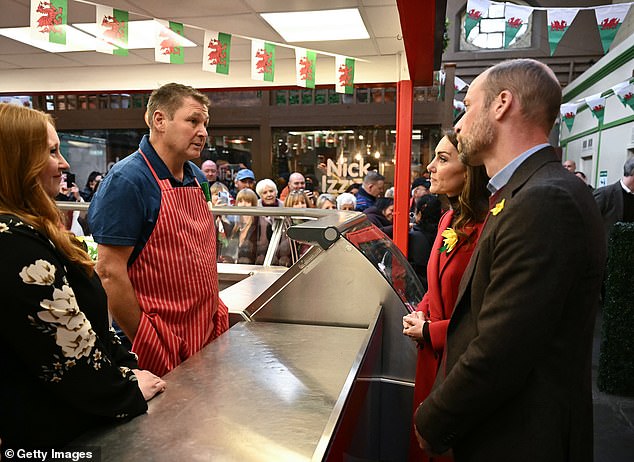 The couple pictured chatting with the owner of Dewhurst Butchers during a visit to Pontypridd Market