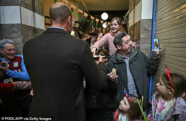 The royal handed out Welsh cakes, as he and Kate walked outside to mingle with the crowds today