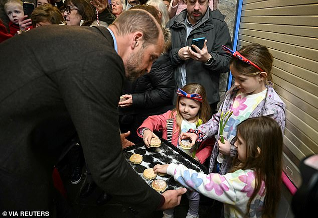 William and Kate distributed cakes to wellwishers during their visit this afternoon, after arriving in Wales