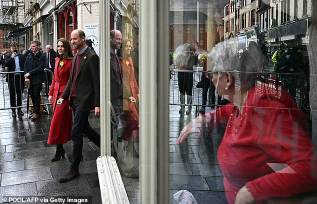 William and Kate braved the grey skies as they strolled alongside one another during the engagement