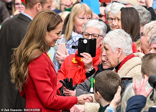 She shook hands with onlookers and attentively listened during chats with wellwishers in Wales today