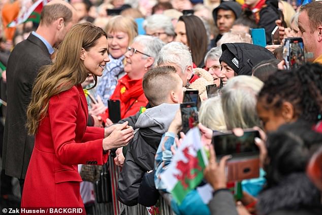 Kate smiled as she spoke with fans, who had gathered to greet her and William in Wales this afternoon