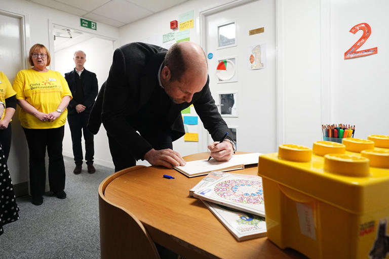 William signs the visitors’ book during a visit to the charity service in Widnes (Aaron Chown/PA) (PA Wire)