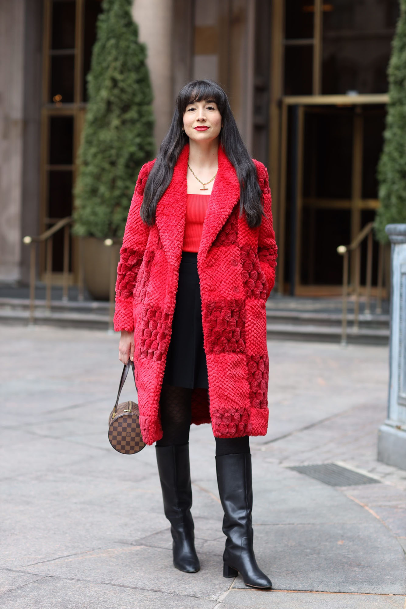 The author wearing a red faux fur coat