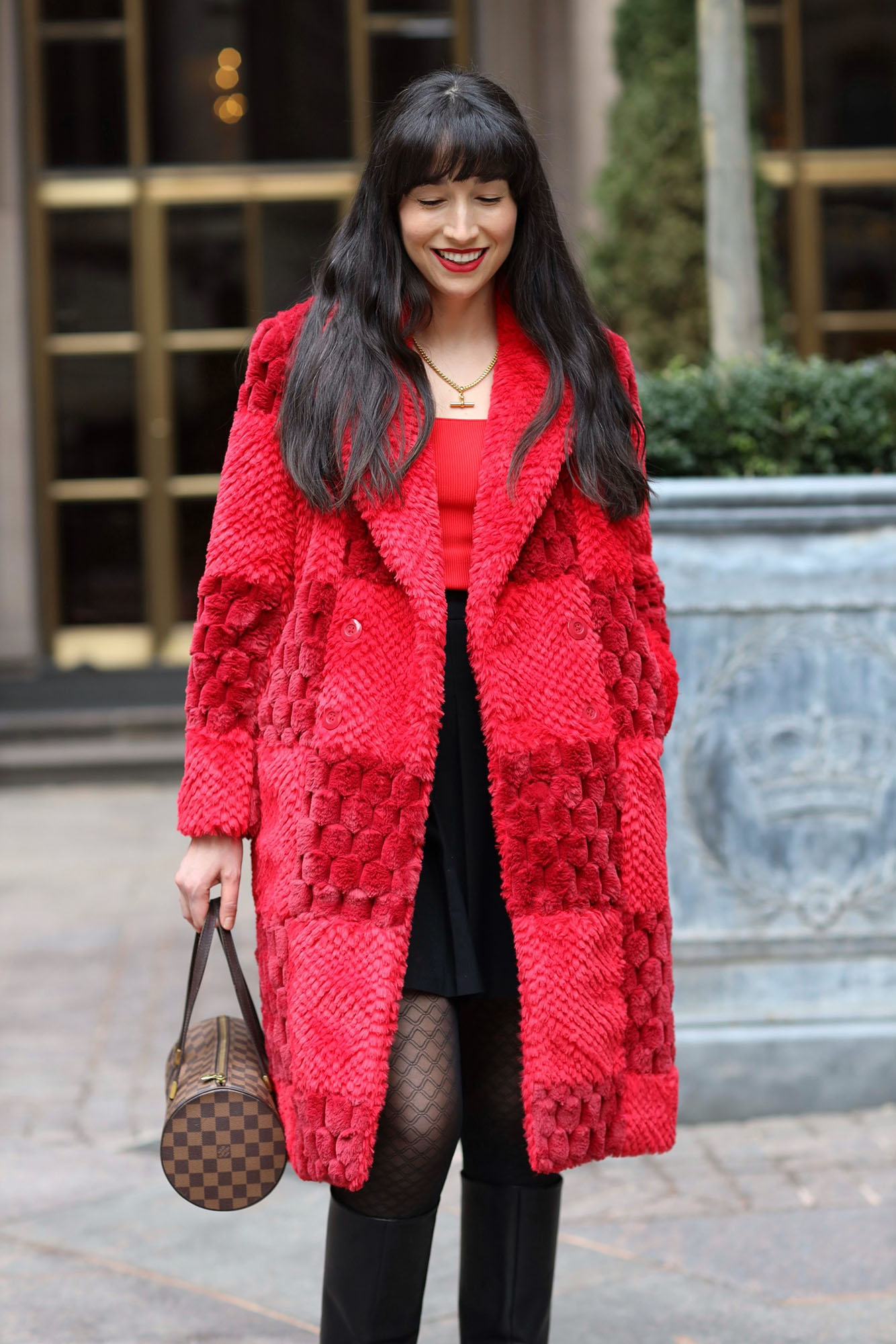 The author wearing a red faux fur coat