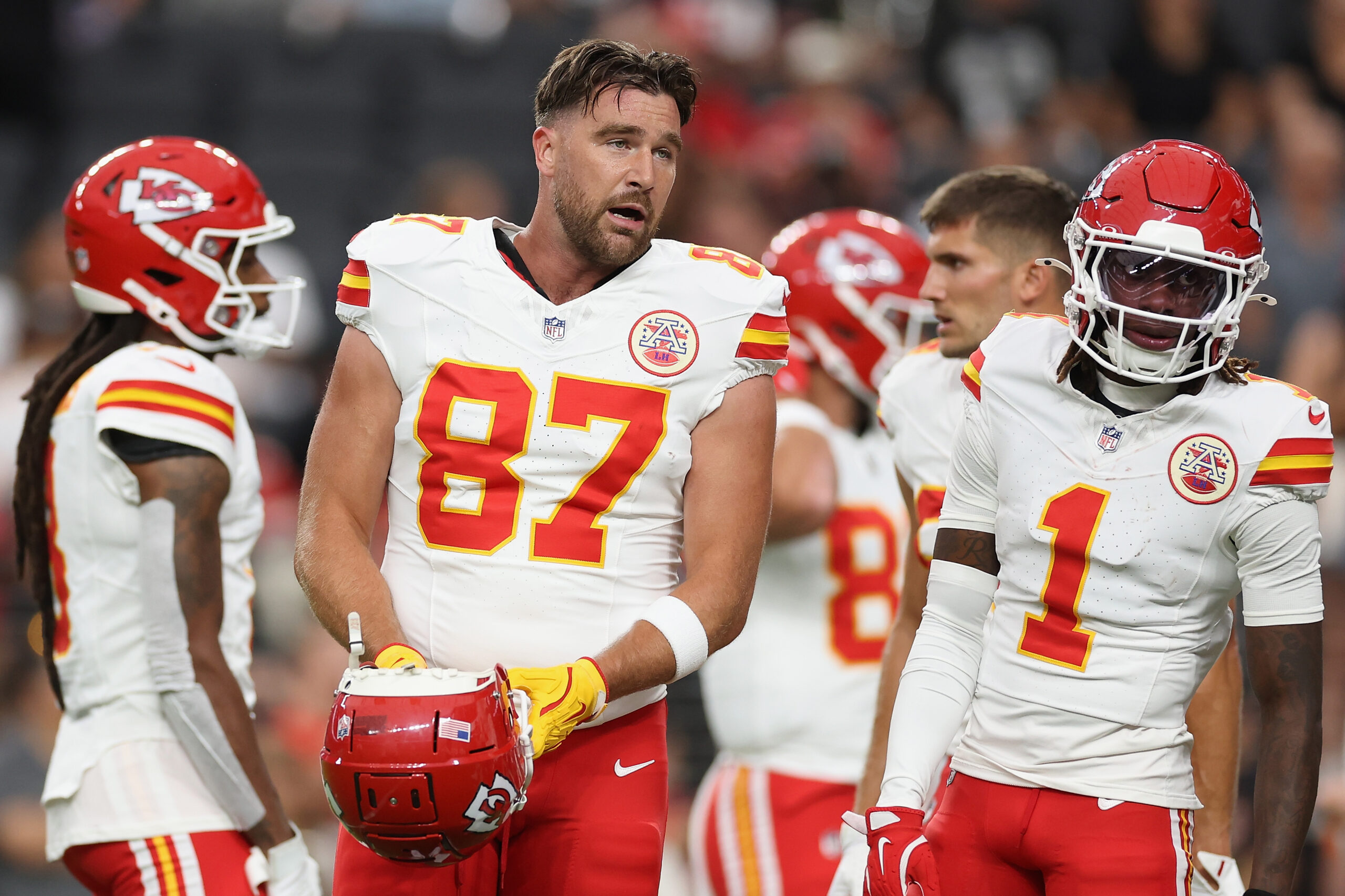 Travis Kelce talking to a teammate.